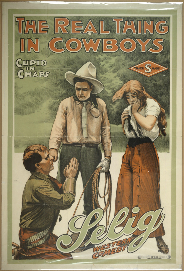 Plakat an einer Wand mit drei Personen in Cowboy-Kleidung und der Aufschrift "The Real Thing in Cowboys" in fetter schwarzer Schrift auf einem hellgelben Hintergrund.